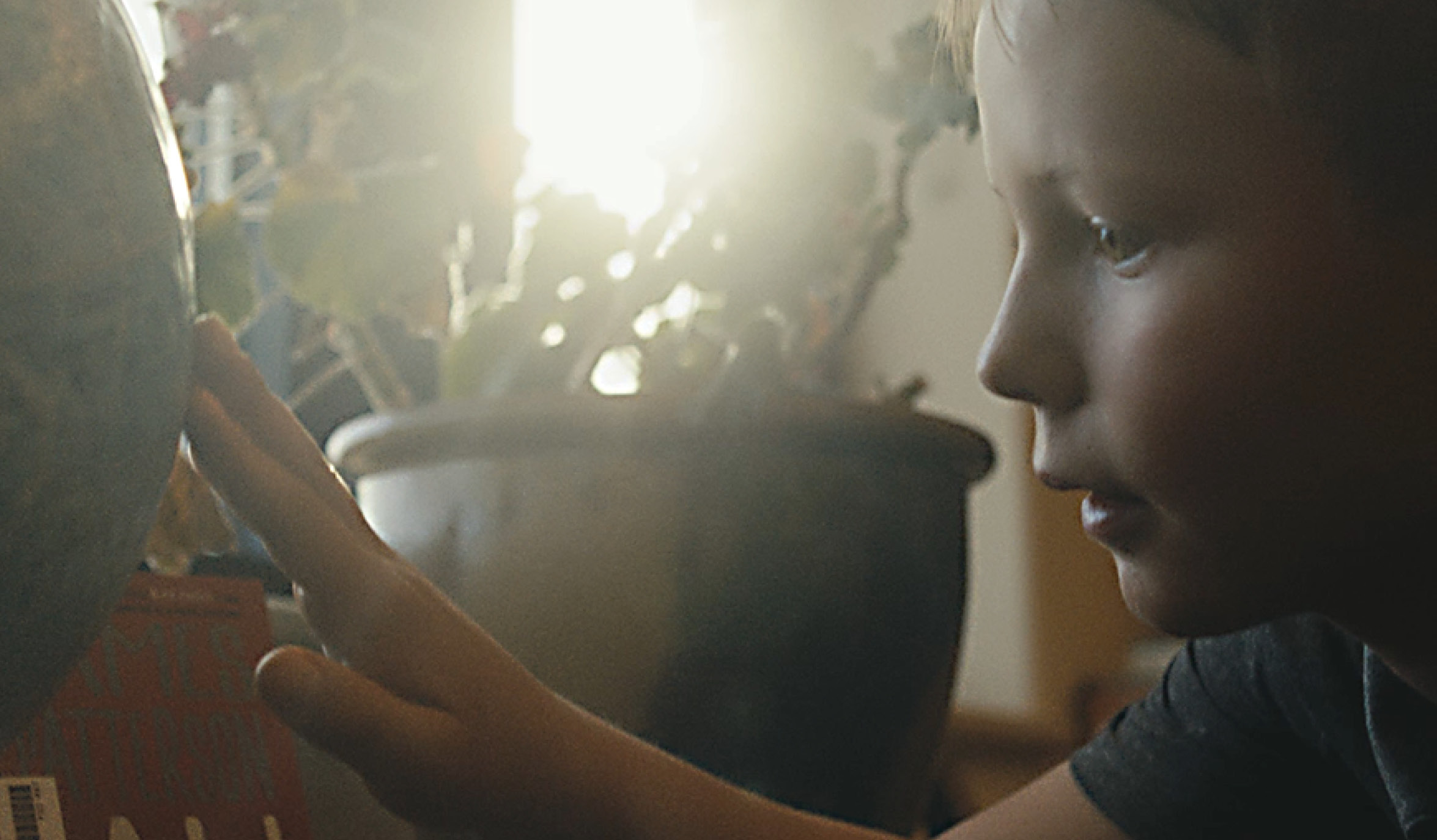 child looking at globe