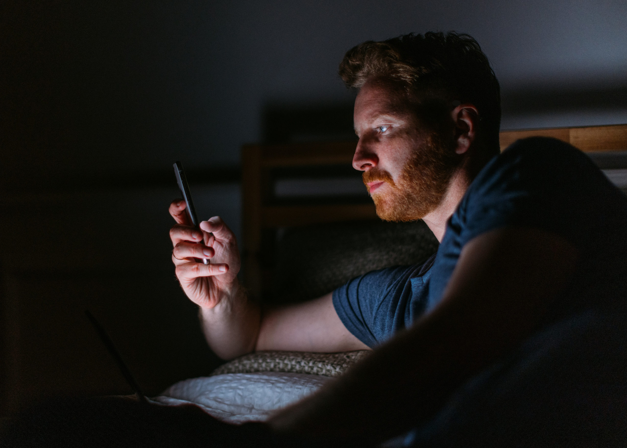 man in dark on phone