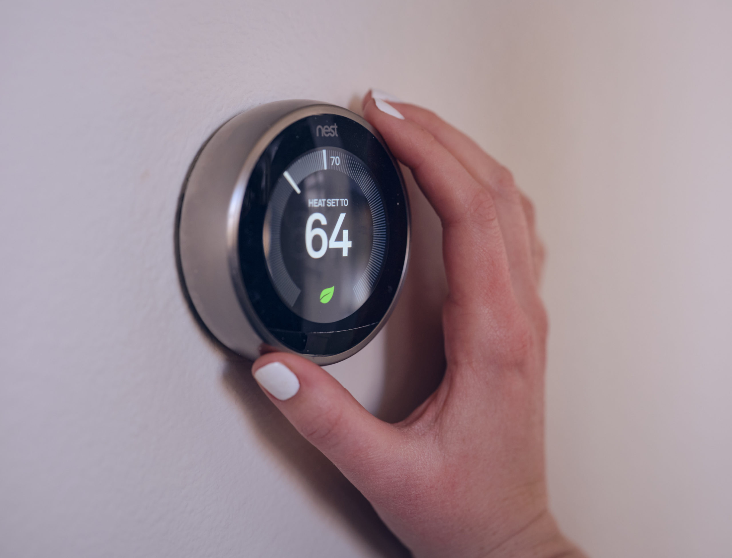 hand adjusting smart thermostat