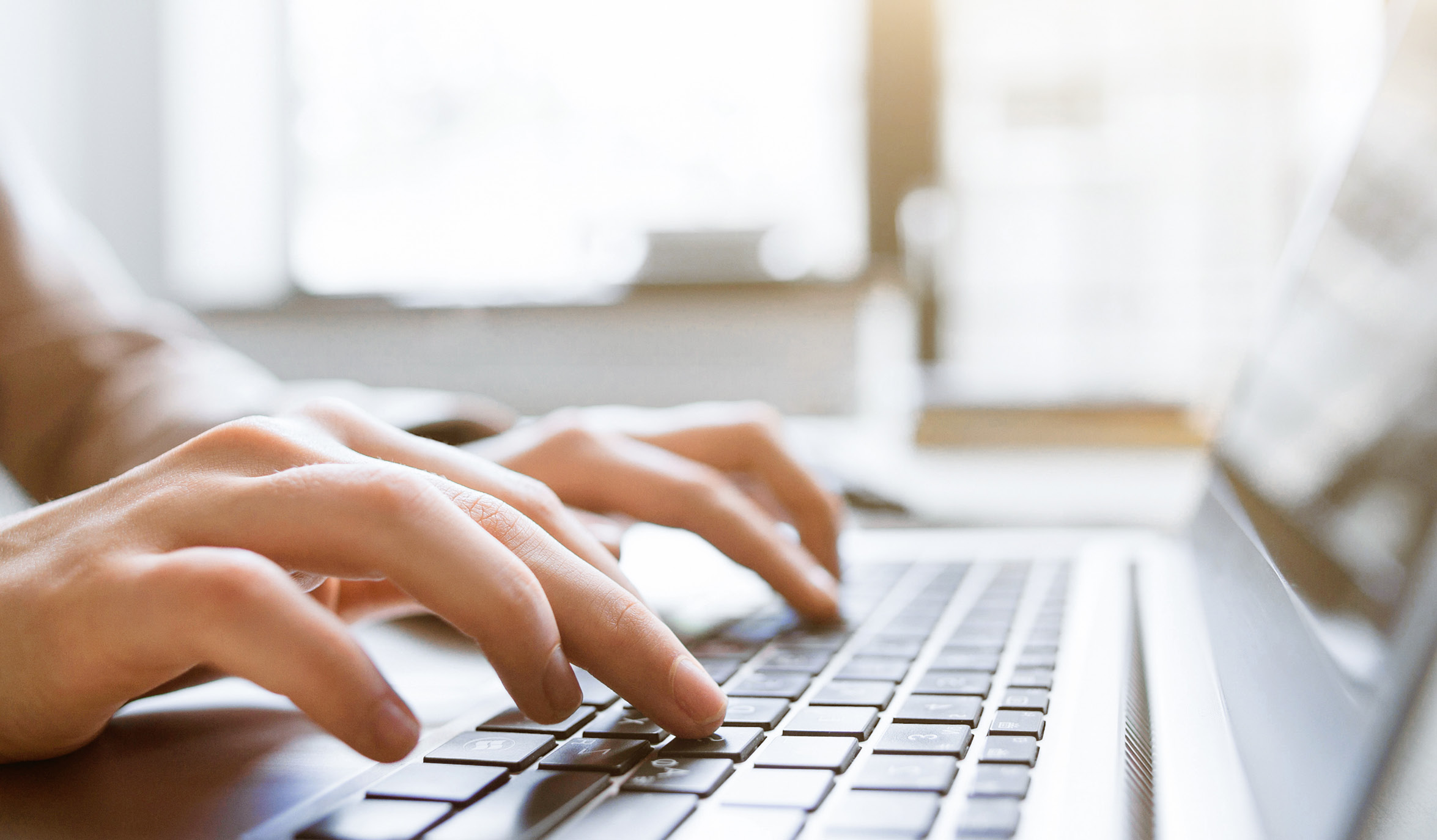 closeup of hands using computer