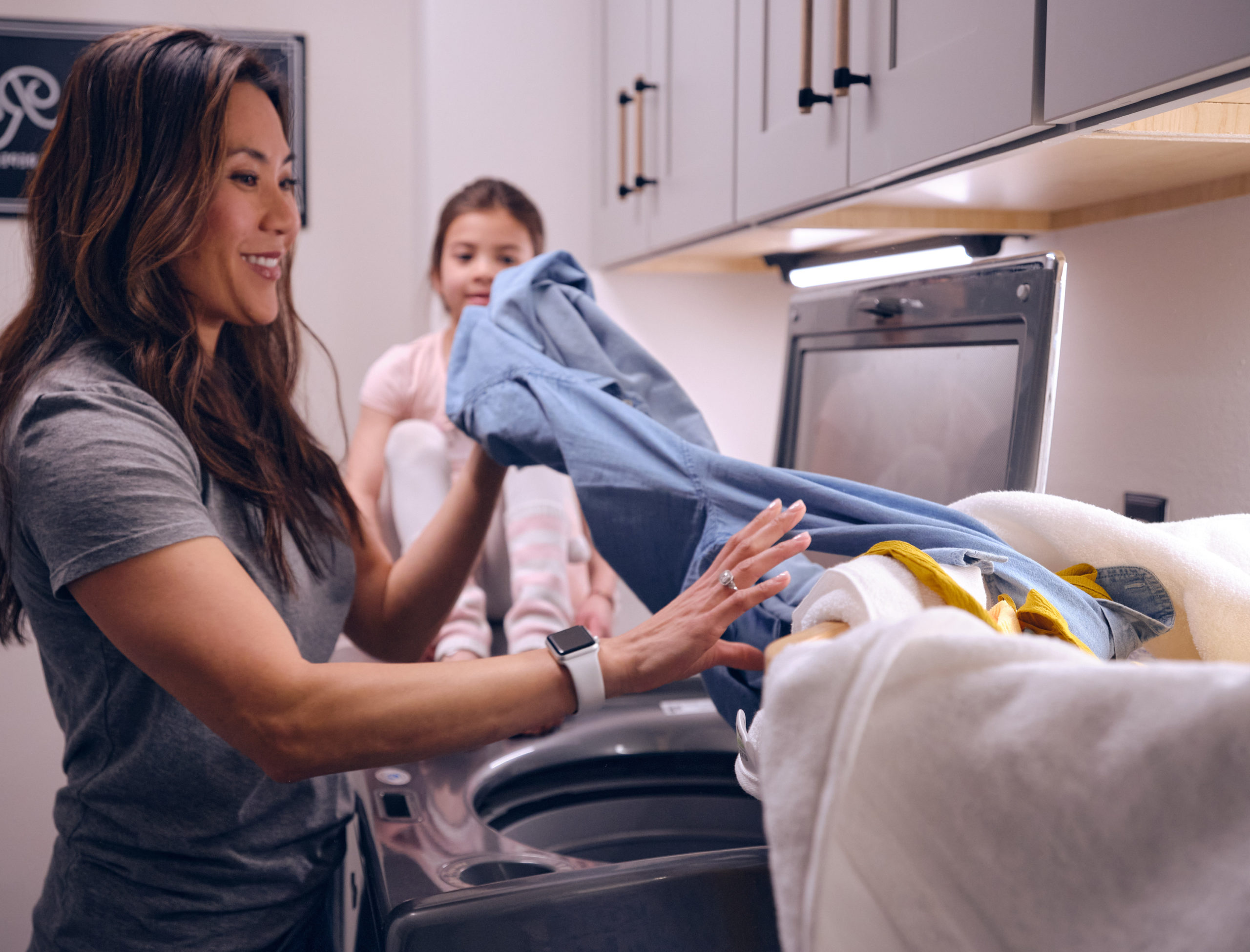 mother and daughter washing clothes