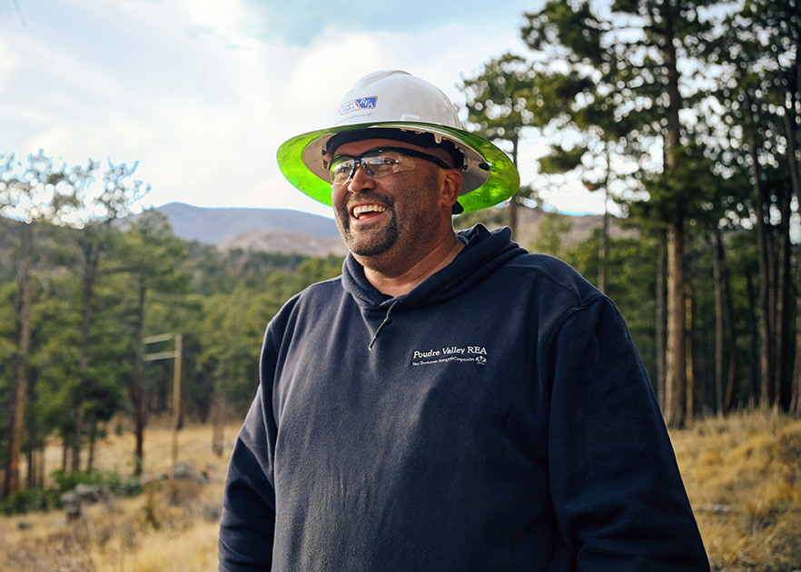 Electrical worker smiling in forest