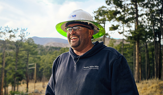 Electrical worker smiling in forest