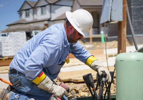 Lineman hooking up lines at a new house