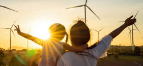 woman and child looking at wind farm