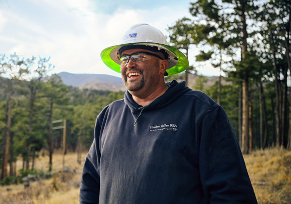 Electrical worker smiling in forest