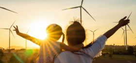 family in front of wind turbines