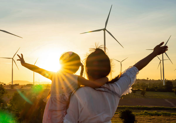 family in front of wind turbines