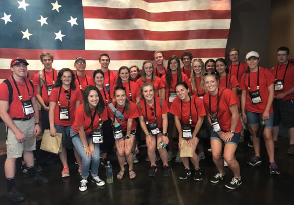 Students in front of flag