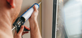 man installing caulking