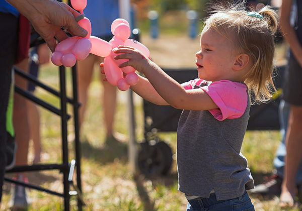 child holding balloon